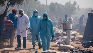 Members of Tunisian security forces dispense disinfectants as they dismantle a makeshift camp for migrants from sub-Saharan Africa at Ben Farhat farm near the Tunisian city of Sfax on April 24, 2025. (Photo by Mohamed KHALIL / AFP)
