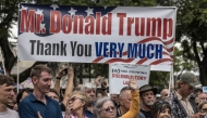 White South Africans supporting US President Donald Trump and South African and US tech billionaire Elon Musk gather in front of the US Embassy in Pretoria. (Photo by Marco Longari / AFP)

