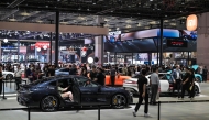 People visit the 21st Shanghai International Automobile Industry Exhibition at the National Exhibition and Convention Center in Shanghai on April 24, 2025. (Photo by Hector RETAMAL / AFP)
