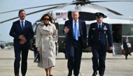 US President Donald Trump and First Lady Melania Trump make their way to board Air Force One before departing from Joint Base Andrews in Maryland on April 25, 2025. Trump is heading to Rome, Italy for the funeral for Pope Francis. (Photo by Mandel Ngan / AFP)
