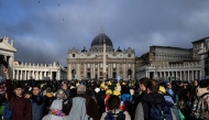 Attendees and nuns stand in front of St Peter's Basilica as they wait for late Pope Francis' funeral ceremony at St Peter's Square in The Vatican on April 26, 2025. (Photo by JEFF PACHOUD / AFP)
