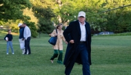US President Donald Trump walks toward the press after arriving on the South Lawn of the White House in Washington, DC, on April 27, 2025. (Photo by Annabelle Gordon / AFP)