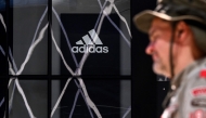 A person walks past a logo of German sportswear giant Adidas on a shop wall in Frankfurt am Main, western Germany, on April 29, 2025. (Photo by Kirill Kudravtsev / AFP)