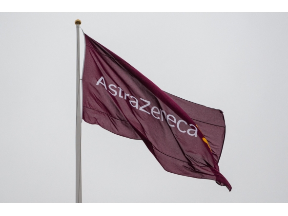 A flag with the logo of pharmaceutical company AstraZeneca flies outside their facility for biological medicines in Södertälje, south of Stockholm, Sweden on February 8, 2022. Photo by Jonathan NACKSTRAND / AFP.

