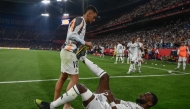 Real Madrid's Spanish midfielder #19 Dani Ceballos helps Real Madrid's German defender #22 Antonio Ruediger during their Spanish Cup, Copa del Rey (King's Cup) final football match between FC Barcelona and Real Madrid CF at La Cartuja stadium in Seville on April 26, 2025. (Photo by Josep LAGO / AFP)