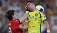 Kawasaki's Japanese goalkeeper #98 Louis Yamaguchi fights for the ball with Nassr's Portuguese forward #7 Cristiano Ronaldo during the AFC Champions League semi-final match between Saudi's Al-Nassr and Japan's Kawasaki at King Abdullah Sports City in Jeddah on April 30, 2025. (Photo by AFP)
