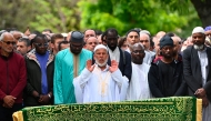 President of the Khadija Mosque, Salim Touazi (C) prays before the coffin of Aboubakar Cisse, a worshipper killed by dozens of stab wounds inside the mosque on April 25th, as part of his funeral prayer, outside the Khadija Mosque in La Grand-Combe, southern France, on May 2, 2025. (Photo by Sylvain THOMAS / AFP)
