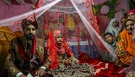 Groom Chaudhry Junaid with his bride, Rabia Bibi, during their wedding ceremony in Ashkot village on the Line of Control (LoC) in Neelum Valley, district of Pakistan-administered Kashmir, on May 3, 2025. (Photo by Farooq Naeem / AFP)