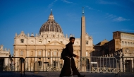 A friar walks in St Peter's square in The Vatican, on May 4, 2025. Photo by Dimitar DILKOFF / AFP