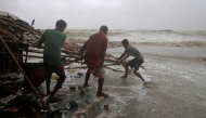 File photo for representational purposes only. Men remove bamboo rooftop of a stall damaged by heavy winds at a shore ahead of Cyclone Yaas in Bichitrapur in Balasore district in the eastern state of Odisha India, May 26, 2021. REUTERS/Rupak De Chowdhuri

