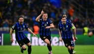 Inter Milan's Italian midfielder #16 Davide Frattesi (C) celebrates scoring his team's fourth goal during the UEFA Champions League semi-final second leg football match between Inter Milan and FC Barcelona at the San Siro stadium in Milan on May 6, 2025. (Photo by Marco BERTORELLO / AFP)
