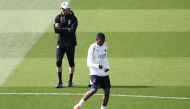 Paris Saint-Germain's French forward #10 Ousmane Dembele, next to Paris Saint-Germain's Spanish headcoach Luis Enrique (L), takes part in a training session on the eve of their second leg semi-final UEFA Champions League match against Arsenal, at the club's training ground in Poissy, west of Paris, on May 6, 2025. (Photo by Franck Fife / AFP)