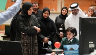 Minister of Education and Higher Education H E Lolwah bint Rashid bin Mohammed Al Khater interacting with a student at the event.