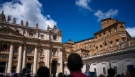 People stand on St Peter's Square after black smoke billowed from a chimney over the Sistine Chapel, on the second day of the conclave, in the Vatican on May 8, 2025. Photo by Dimitar DILKOFF / AFP