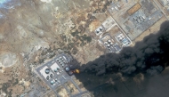 This handout satellite photo obtained from Planet Labs PBC and dated May 6, 2025, shows smoke billowing from a fuel storage depot after a strike on Port Sudan. (Photo by Planet Labs PBC / AFP)