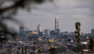 A general view of the Alexandra township with the Sandton cityscape in the background taken from Linbro Park in Johannesburg on May 4, 2025. (Photo by EMMANUEL CROSET / AFP)