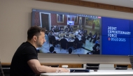 In this handout photograph taken and released by the Ukrainian Presidential Press Service on May 9, 2025, Ukraine's President Volodymyr Zelensky attends the annual Joint Expeditionary Force (JEF) Leaders' Summit, taking place in Oslo, via video link from his office in Kyiv. (Photo by Handout / AFP) 