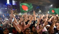 Bangladeshis celebrate after the interim government officially banned all activities of the Awami League (AL) under the Anti-Terrorism Act, pending the conclusion of the International Crimes Tribunal (ICT) trials against the party and its leaders, in Dhaka on May 10, 2025. (Photo by MUNIR UZ ZAMAN / AFP)