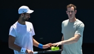 (Files) Serbia's Novak Djokovic (L) and his coach Andy Murray talk during a practice session ahead of the Australian Open tennis tournament in Melbourne on January 11, 2025. (Photo by William West / AFP) 