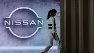(Files) This file photo taken on July 28, 2020 shows a staff member walking off stage at the end of a presentation in the showroom at Nissan's global headquarters in Yokohama. (Photo by Philip Fong / AFP)