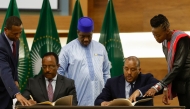 In this file photo taken on November 02, 2022 Redwan Hussein (2nd L), Representative of the Ethiopian government, and Getachew Reda (2nd R), Representative of the Tigray People's Liberation Front (TPLF), sign a peace agreement between the two parties during a press conference regarding the African Union-led negotiations to resolve conflict in Ethiopia at the Department of International Relations and Cooperation (DIRCO) offices in Pretoria.(Photo by PHILL MAGAKOE / AFP)

