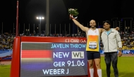 Germany's Julian Weber celebrates his world leading score with India's Neeraj Chopra (R) after the men's Javelin throw final during the IAAF Diamond League competition at the Suheim Bin Hamad Stadium in Doha on May 16, 2025. (Photo by Karim Jaafar / AFP)