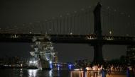 People gather to look at a Mexican Navy training ship near the Manhattan Bridge after it slammed into the nearby Brooklyn Bridge in New York on May 17, 2025. (Photo by Angela Weiss / AFPTV / AFP)