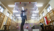 A voter casts his voting ballot at a polling station in Warsaw, Poland, on May 18, 2025, during the first round of the presidential elections. (Photo by Wojtek Radwanski / AFP)