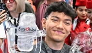 Austrian singer Johannes Pietsch aka JJ, winner of the 2025 Eurovision Song Contest, holds up the trophy as he arrives at Vienna International Airport in Schwechat, Austria on May 18, 2025. (Photo by Joe Klamar / AFP) /