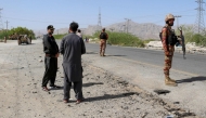 Security personnel stand guard at the site of a school bus bombing in Khuzdar district of Balochistan province on May 21, 2025. (Photo by AFP)