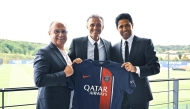 Qatar Sports Investments Chairman Nasser Al-Khelaifi (right), PSG coach Luis Enrique (centre) and QSI Sports Advisor Luis Campos hold a PSG jersey. 