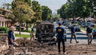 Members of the the Federal Bureau of Investigation (FBI) walk around the crash site after a small plane crashed into a neighborhood, setting homes and vehicles on fire on May 22, 2025 in San Diego, California. Ariana Drehsler/Getty Images/AFP 