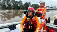 This handout photo taken and released on May 21, 2025 by the New South Wales State Emergency Service (NSWSES) shows SES officials on patrol in flood-affected areas in and around Taree. (Photo by Handout / New South Wales State Emergency Service / AFP)