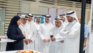 Minister of Municipality H E Abdullah bin Hamad bin Abdullah Al-Attiya and QU President Dr. Omar Al-Ansari with other officials touring the exhibition.