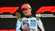 McLaren's British driver Lando Norris looks at the trophy on the podium after winning the Formula One Monaco Grand Prix at the Circuit de Monaco, on May 25, 2025. (Photo by Andrej Isakovic / AFP)