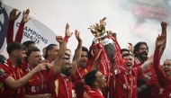 Liverpool's celebrate with the Premier League trophy at the end of the English Premier League football match between Liverpool and Crystal Palace at Anfield in Liverpool, north west England on May 25, 2025. (Photo by Paul Ellis / AFP) 