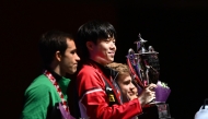 Men's singles champion Wang Chuqin (centre) of China with the podium winners during the presentation ceremony. (Photo by XHINHUA)