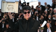 Iranian director and screenwriter and producer Jafar Panahi poses with the trophy during a photocall after winning the Palme d'Or for the film 