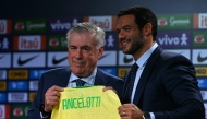 Brazil's football team new head coach, Italian Carlo Ancelotti (left) receives the team's jersey from the president of the Brazilian Football Confederation (CBF) Samir Xaud during his official presentation at a hotel in Barra da Tijuca neighbourhood, Rio de Janeiro, Brazil, on May 26, 2025. (Photo by Mauro Pimentel / AFP)
