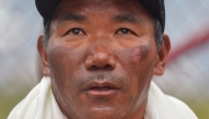 (Files) Nepali guide Kami Rita Sherpa who reached the top of Mount Everest on May 23, 2023, for a record 28th time looks on after his arrival at the Tribhuvan airport in Kathmandu on May 25, 2023. (Photo by Nisha Bhandari / AFP)
