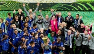 Chelsea's players and team members celebrate with the trophy during the awarding ceremony after winning the UEFA Conference League final football match between Real Betis and Chelsea FC in Wroclaw on May 28, 2025. (Photo by Wojtek RADWANSKI / AFP)