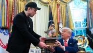US President Donald Trump gives to Elon Musk a 