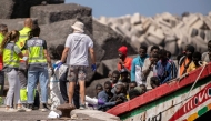 File photo: Members of police forces and emergency services help 175 migrant people on board a boat, upon its arrival at Restinga port on the Canary island of El Hierro on August 18, 2024. (Photo by Antonio Sempere / AFP)