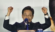 Lee Jae-myung, the presidential candidate for South Korea's Democratic Party, acknowledges supporters as he awaits the final results of the presidential election in Seoul on June 4, 2025. (Photo by Anthony Wallace / AFP)
