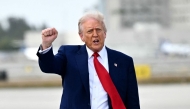 US President Donald Trump pumps his fist upon arrival at Miami International Airport on April 3, 2025. (Photo by Mandel Ngan / AFP)