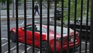 A Tesla automobile owned by President Donald Trump (he does not drive it, but some staffers do) is parked in a lot next to the White House fence Thursday. Michael S. Williamson/The Washington Post