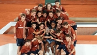 Coco Gauff of the US poses with the ball boys and ball girls after winning the French Open women's singles title.