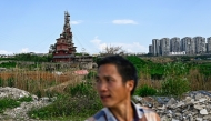 This picture taken on May 20, 2025 shows Chen Tianming standing near his house labelled China's strangest 