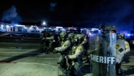 Law enforcement clash with demonstrators during a protest following federal immigration operations, in the Compton neighborhood of Los Angeles, California early on June 8, 2025. (Photo by Etienne Laurent / AFP)