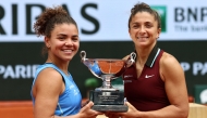 Italy's Jasmine Paolini (L) and Italy's Sara Errani pose with their trophy after winning their women's doubles final match in Paris on June 8, 2025. (Photo by Thibaud Moritz / AFP)
 